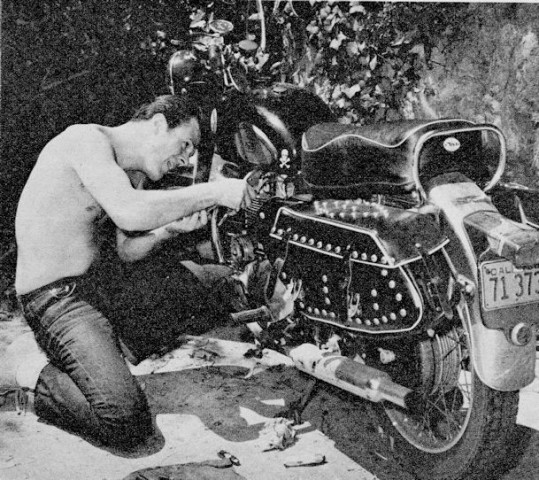 Robert Culp working on his motorcycle, circa 1959